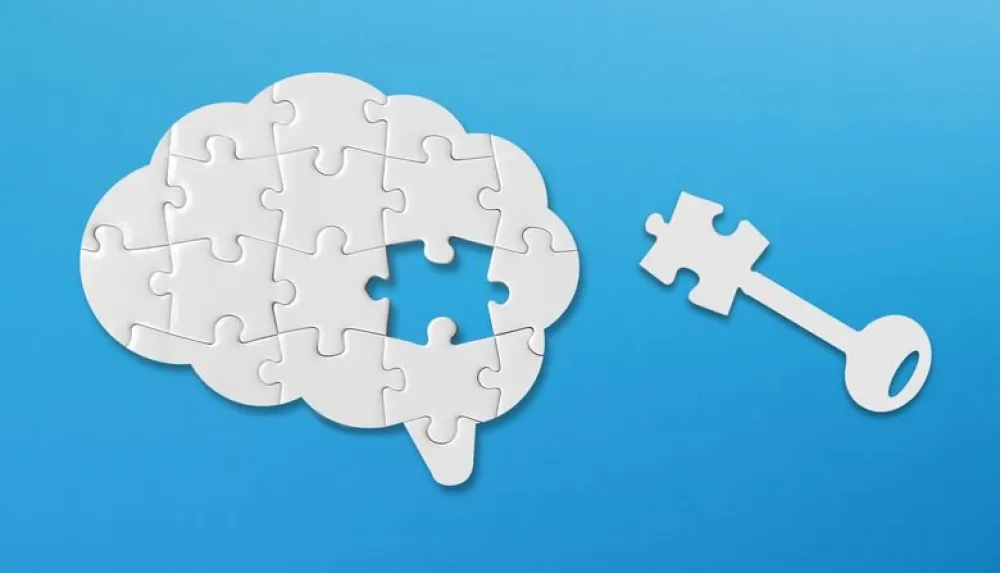 Un puzzle con forma de cerebro con una de las piezas separada simbolizando una llave